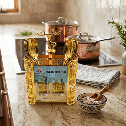 Decorative gold spoon holder with a deer design on a kitchen counter.