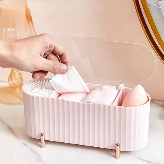 Pink makeup organizer with various items on a light background