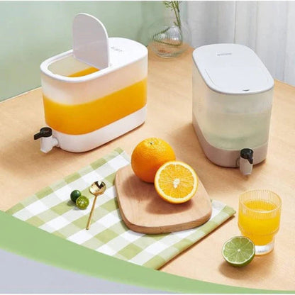 Juicer with oranges, a glass of juice, and a cutting board on a table.