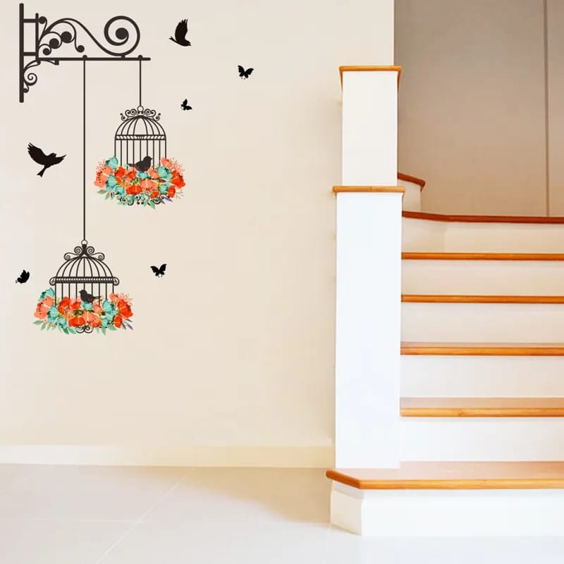 Decorative wall stickers of birdcages with floral designs on a staircase wall.