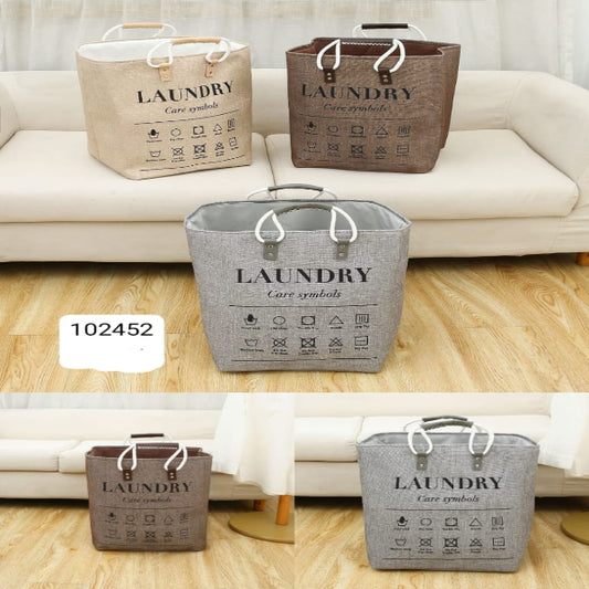 Foldable laundry baskets in beige, brown, and gray colors, with 'LAUNDRY' text printed on the sides, displayed in a home setting.