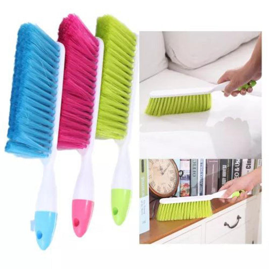Set of colorful cleaning brushes with a person using one on a surface.