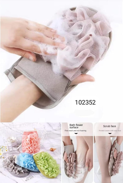 Hand using a gray scrubber with floral design on a white background, showing product details.