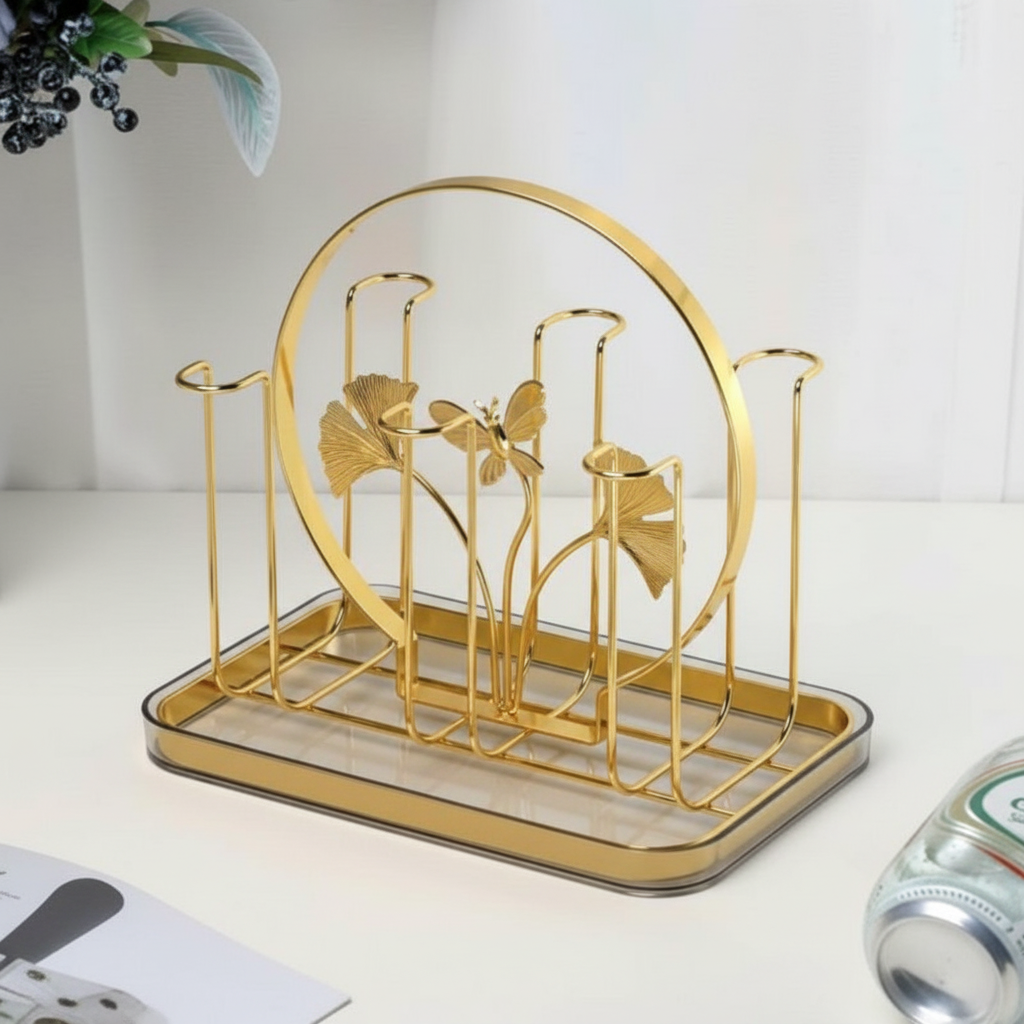 Gold decorative rack with leaf design on a white surface