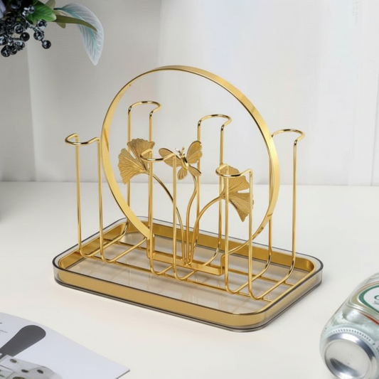 Gold decorative rack with leaf design on a white surface