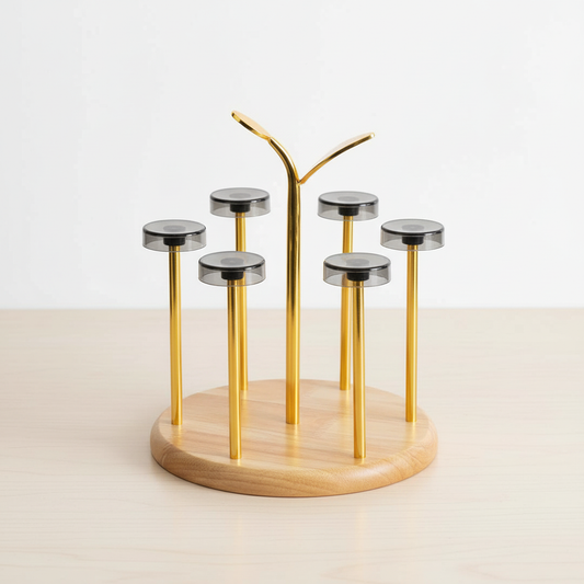 Gold and wooden jewelry stand with multiple cylindrical holders on a light background