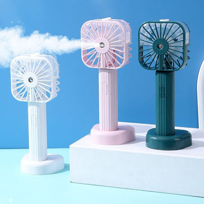 Three portable fans in white, pink, and green on a blue background
