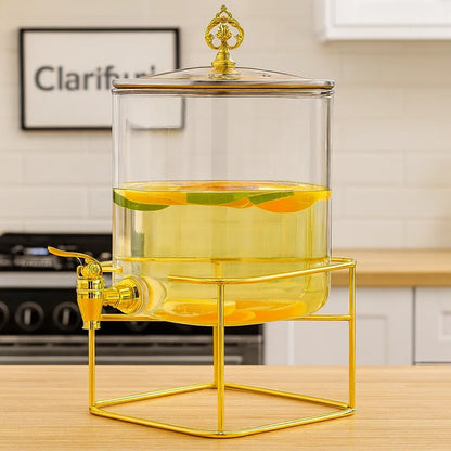 Clear drink dispenser with gold accents on a kitchen counter